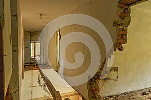 Remains of abandoned damaged and destroyed house interior with collapsed floor and wal.