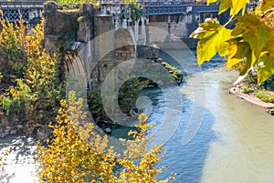 The remains of the ancient Ponte Rotto Broken Bridge with Isola Tiberina in the background, Roma photo
