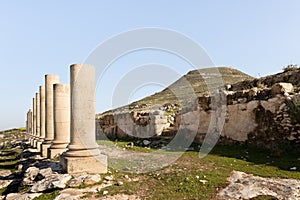 The remains  of columns in the ruins of the palace of King Herod - Herodion, against the background of the filled artificial hill