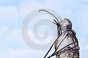 Remains of the destroyed industrial building. A piece of concrete beams with the rebar looks up to the sky