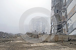 The remains of a large concrete building in the form of fragments of piles and piles of stones