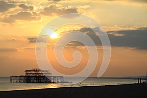 Remains of old Brighton Pier left standing in sea at sunset,, England, UK