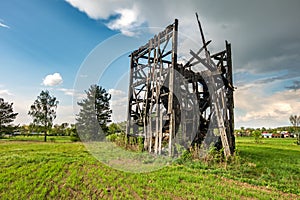 Remains of old burnt windmill in the field before the rain