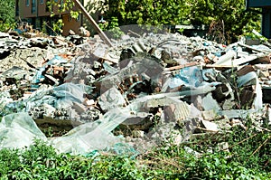 Remains of old ruined house on the place where will be new residential building.