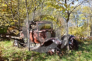 Remains of an old rusty truck in a woods