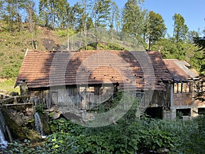 Remains of an old sawmill on the small dam of ÄŒogrljevo Lake in the mountain hamlet of TiÄ‡i - Gorski kotar, Croatia