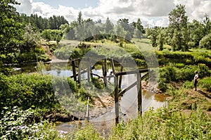 Remains of an old wooden bridge by the Irbe river, Latvia photo