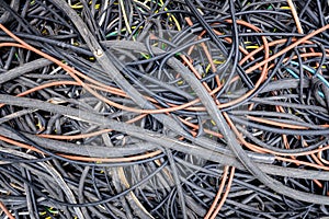Remains of plastic electrical cables abandoned in a field by thieves