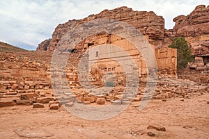 Remains of Qasr Al Bint temple in Petra, Jordan, rocky mountains background