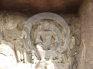 Remains of sculpture of a seated Buddha outside Aurangabad Cave 4, Maharashtra, India