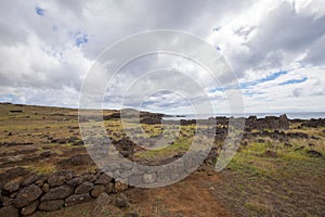 Remains of stone structures and the toppled moai Te Pito Kura along the northern coast of Easter Island. Easter Island, Chile