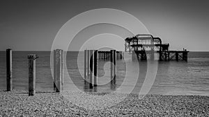 Remains of the west pier in the Brighton, the old pier built in 1866 and burned down back in 1975 in England, UK in black and