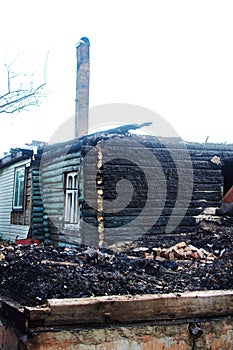 The remains of the wooden house after the fire