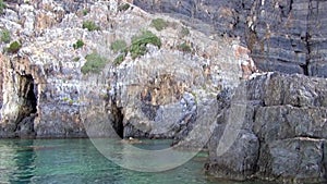 Remarkable cliff and sea stacks with clear water. Seaboard.