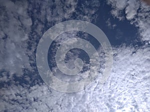 A remarkable snapshot of an eye-catching view of a pattern of clusters of white clouds in blue sky