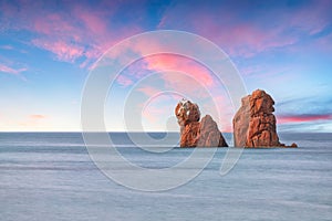 Remarkable sunset view of Red Rocks (is Scoglius Arrubius) on Cea beach photo