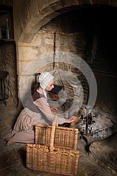 Rembrandt portrait of woman at fireplace