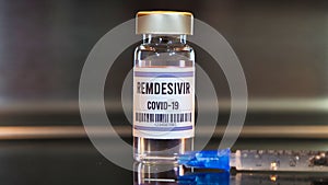 Remdesivir drug and syringe on black table photo