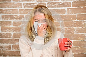 Remedies should help beat cold fast. Tips how to get rid of cold. Woman feels badly ill sneezing. Girl in scarf hold tea