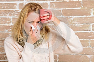 Remedies should help beat cold fast. Woman feels badly ill sneezing. Cold and flu remedies. Girl in scarf hold tissue or