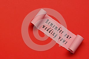Remember our wedding vows label on torn paper with red paper background