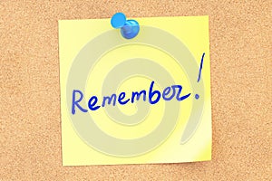 Remember text on a sticky note pinned to a corkboard. 3D rendering