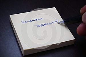 Remember yesterday ? Message written with pen on notepad.