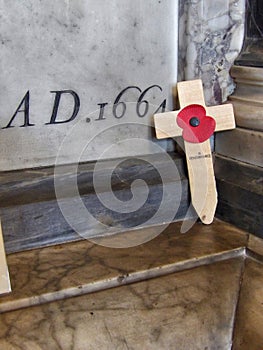 Rememberance poppy on cross crucifix in church