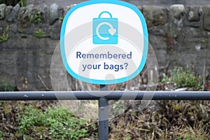 Remembered your plastic bags sign at supermarket retail shop sign