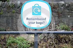 Remembered your plastic bags sign at supermarket retail shop sign photo