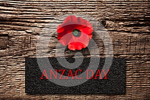 The remembrance poppy - poppy appeal. Poppy flower on black textured background. Decorative flower for Anzac Day.