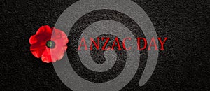 The remembrance poppy - poppy appeal. Poppy flower on black textured background. Decorative flower for Anzac Day.