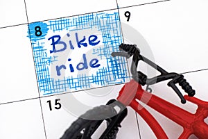 Reminder Bike ride in calendar with bicycle toy