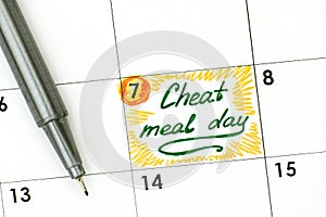 Reminder Cheat Meal Day in calendar with green pen.