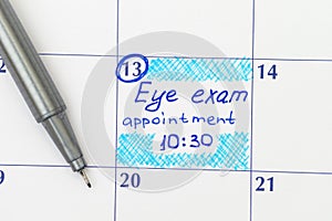 Reminder Eye exam appointment in calendar with pen