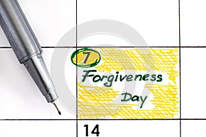 Reminder Forgiveness Day in calendar with pen