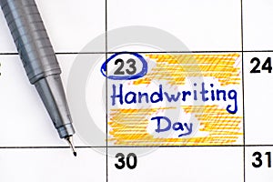 Reminder Handwriting Day in calendar with pen