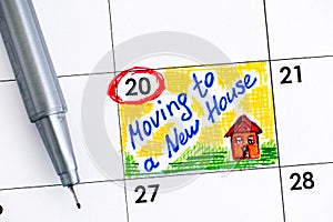 Reminder Moving to a New House in calendar with pen.