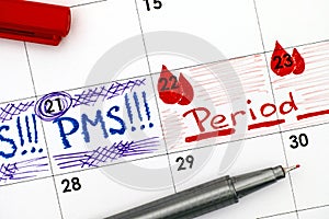 Reminder PMS and Period in calendar with red pen.