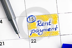 Reminder Rent Payment in calendar with blue pen.