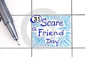 Reminder Scare a Friend Day in calendar with pen