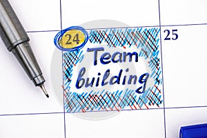 Reminder Team building in calendar with pen