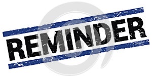 REMINDER text on black-blue rectangle stamp sign