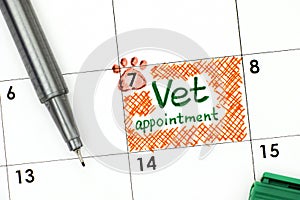 Reminder Vet Appointment in calendar with green pen. photo