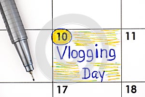 Reminder Vlogging Day in calendar with pen