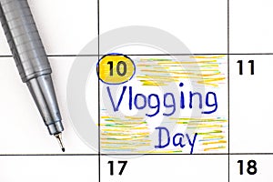 Reminder Vlogging Day in calendar with pen photo