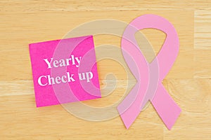 Reminder for yearly checkup with pink cancer ribbon