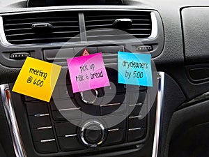reminders on colorful sticky notes in car