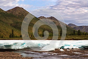 Remnants of spring ice in the valley of a mountain river.