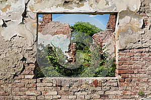 Remnants of Time: Ruined Window and Weathered Red Brick Wall in an Abandoned House